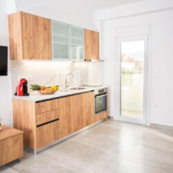 Compact kitchen with an oven, two cooking hobs, and a fridge for your convenience.