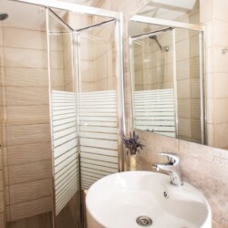 Modern bathroom with walk-in shower in beachfront studio in Matala, Crete